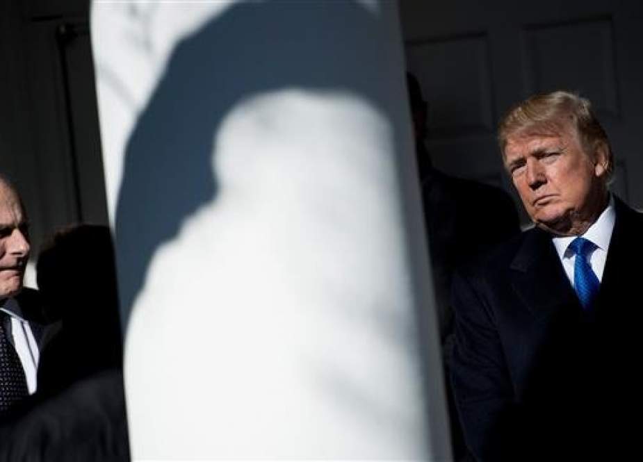 In this AFP file photo taken on January 19, 2018 White House Chief of Staff John Kelly (L) waits for US President Donald Trump (R) to speak live via video link to the annual "March for Life" participants and anti-abortion leaders, from the White House in Washington,DC.