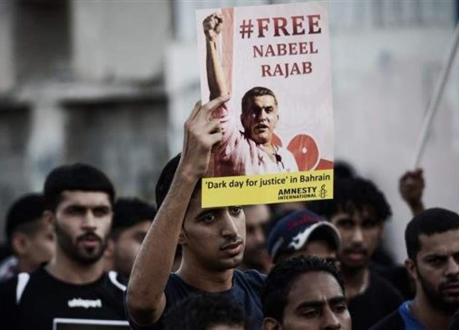 A Bahraini protester shows a poster asking for the release of jailed human right activist Nabeel Rajab during a protest in the village of al-Malkiyah, South of Manama, on August 27, 2013. (Photo by AFP)