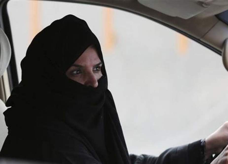 In this March 29, 2014 file photo, a woman drives a car on a highway in Riyadh, Saudi Arabia, as part of a campaign to defy Saudi Arabia