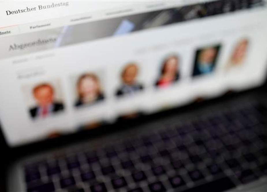 A picture taken on January 4, 2019 shows the website of the German Bundestag (lower house of parliament) with pictures of delegates displayed on the screen of a laptop. (Photo by AFP)