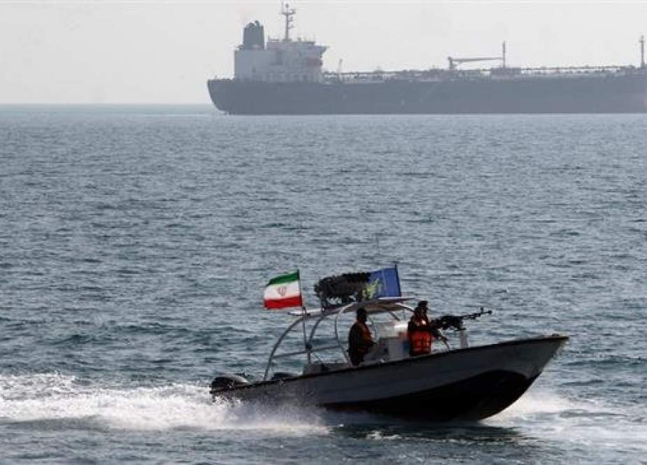 Iranian guards drive a speedboat in front of an oil tanker during a ceremony to commemorate the 24th anniversary of the downing of Iran Air flight 655 by the US navy, at the port of Bandar Abbas on July 2, 2012. (Photo by AFP)