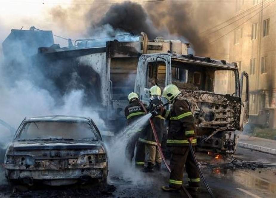 This picture, released by O Povo, shows firefighters putting out a burning truck and car during a wave of gang violence in Brazil’s northeastern city of Fortaleza, Ceara State, on January 3, 2019. (Via AFP)
