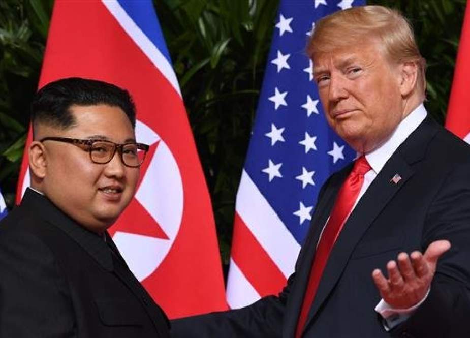 In this file photo taken on June 12, 2018 US President Donald Trump (R) gestures as he meets with North Korea