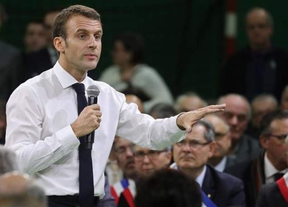 French President Emmanuel Macron gestures during a meeting gathering some 600 mayors who will relay the concerns aired by residents in their towns and villages in the Normandy city of Grand Bourgtheroulde on January 15, 2019. (Photo by AFP)