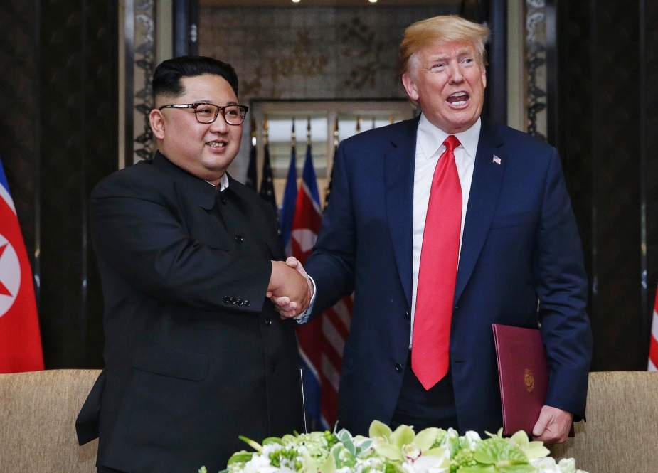 President Donald Trump (R) gestures as he meets with North Korea