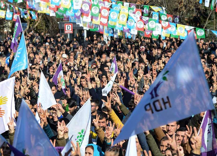 Protesters flash the V sign for victory during a rally in the Kurdish-majority city of Diyarbakir, southeastern Turkey, January 19 , 2019. (AFP)
