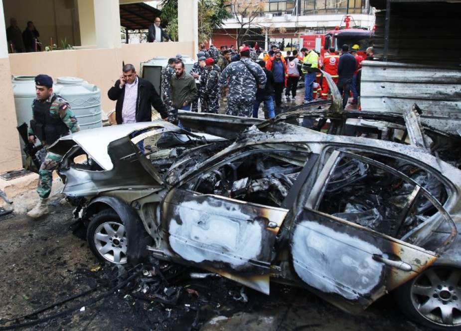 Lebanese security forces stand near a damaged vehicle following a car bomb blast in the southern Lebanese port city of Sidon on January 14, 2018. (Photo by AFP)