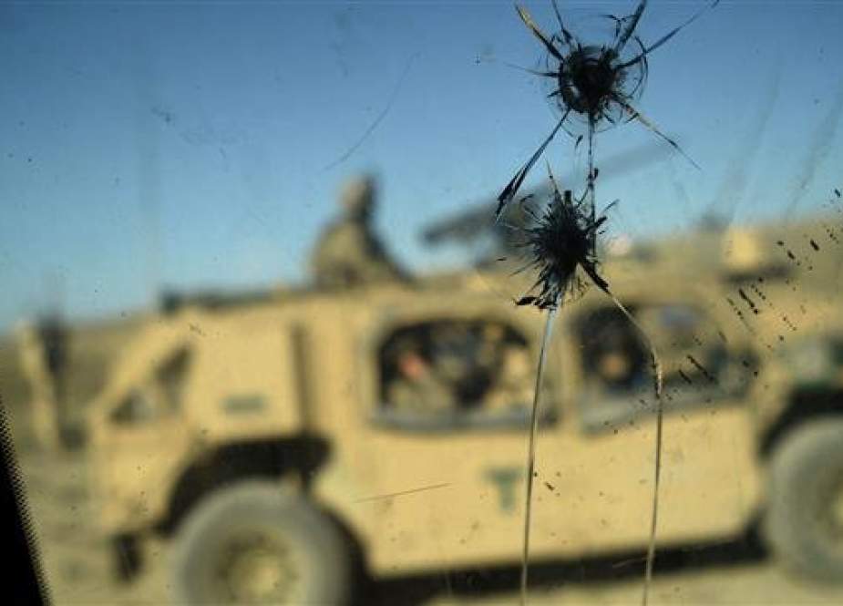 In this picture taken on July 07, 2018, US Army soldiers from NATO are seen through a cracked window of an armed vehicle in a checkpoint during a patrol against Daesh terrorists in the eastern province of Nangarhar. (Photo by AFP)