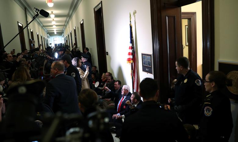 Demonstrators engage in civil disobedience in the hallway outside Senate Majority Leader Mitch McConnell's office before being detained by Capitol police officers during a protest in the Russell Senate office building on Capitol Hill in Washington, Janua