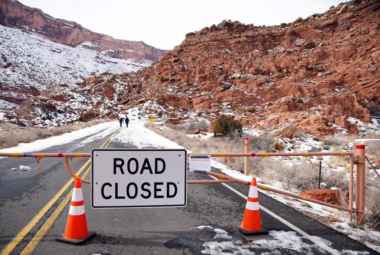Two hikers walk up the main road, which is closed because of the partial government shutdown, in Arches National Park, Utah, January 9.