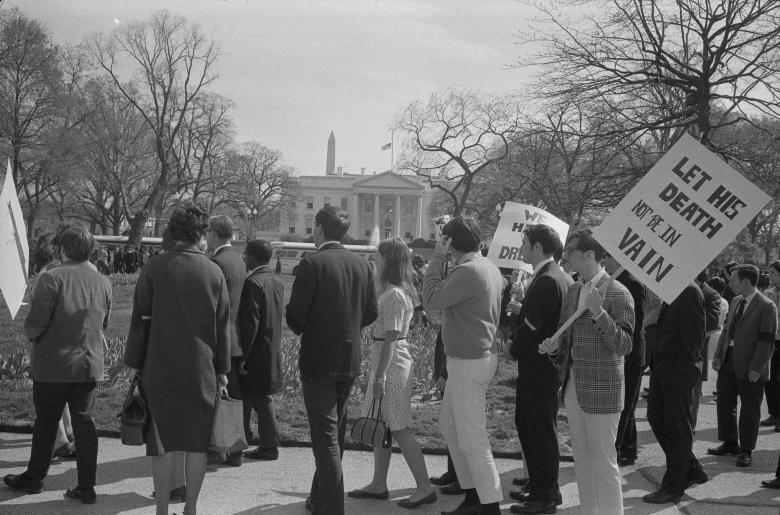 People demonstrate after the assassination of Martin Luther King Jr. in front of the White House in Washington, April 1968. The sign reads: 