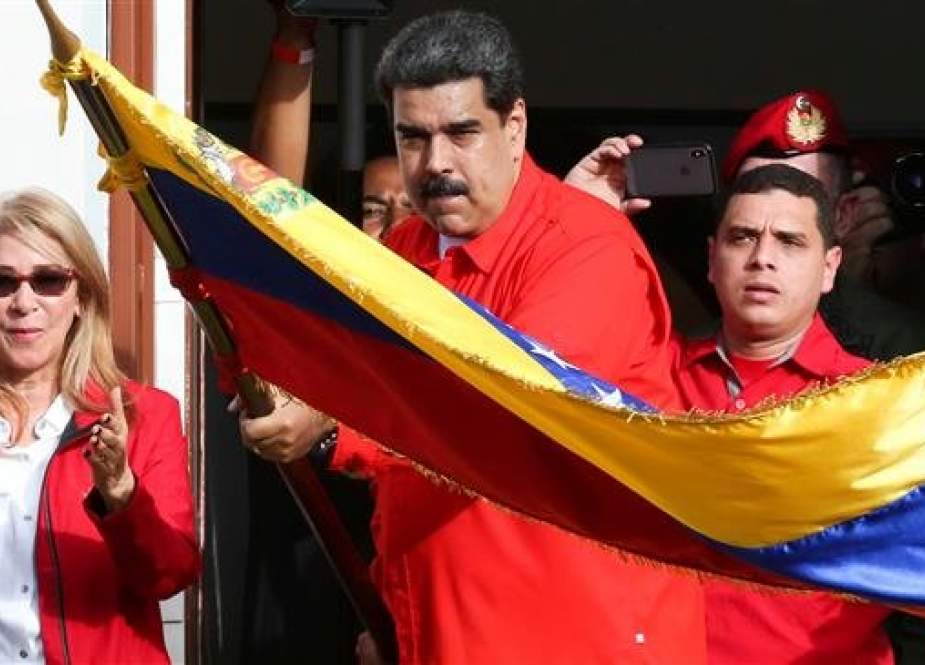 Venezuelan President Nicolas Maduro attends a rally in support of his government and to commemorate the 61st anniversary of the end of the dictatorship of Marcos Perez Jimenez next to his wife Cilia Flores in Caracas, Venezuela, January 23, 2019. (Photo by Reuters)
