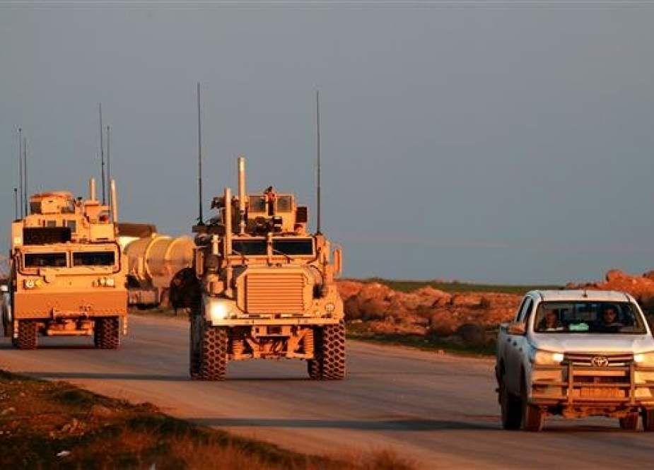 File photo of US Marine Corps tactical vehicles being escorted by a Syrian Democratic Forces (SDF) pickup truck along a road near the town of Tal Baydar in the countryside of Syria. (Photo by AFP)
