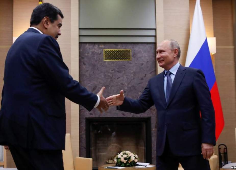 This file photo shows Russian President Vladimir Putin (R) shaking hands with Venezuelan President Nicolas Maduro during a meeting at the Novo-Ogaryovo state residence, outside Moscow, Russia, on December 5, 2018.