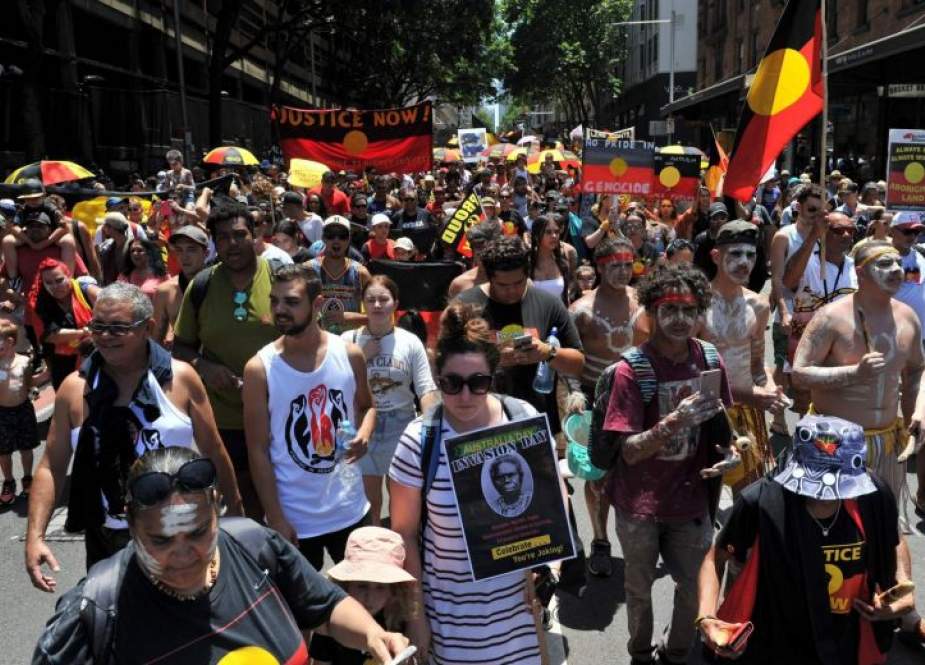 Protesters march through the streets of Sydney in an "Invasion Day" rally on Australia Day on January 26, 2019. (Photo by AFP)