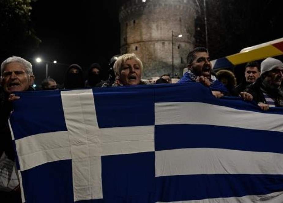Protesters demonstrate next to the White tower against an agreement to rename Greece