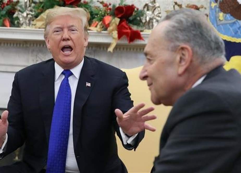 US President Donald Trump argues about border security with Senate Minority Leader Chuck Schumer (D-NY) in the Oval Office on December 11, 2018 in Washington, DC. (Photo by AFP)