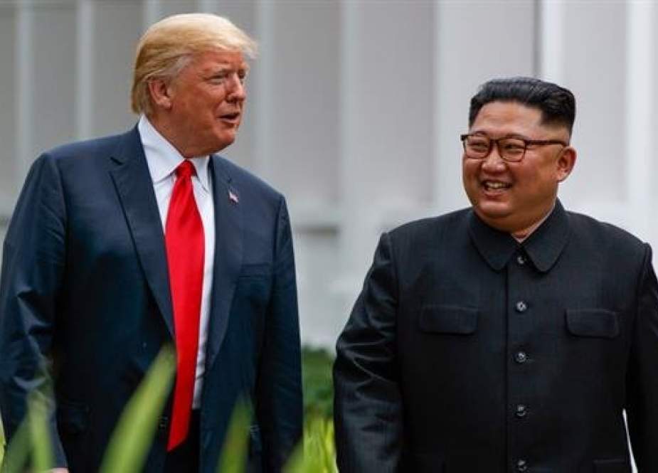 US President Donald Trump (L) and North Korea leader Kim Jong-un walk from their lunch at the Capella resort on Sentosa Island in Singapore on June 12, 2018. (Photo via AP)