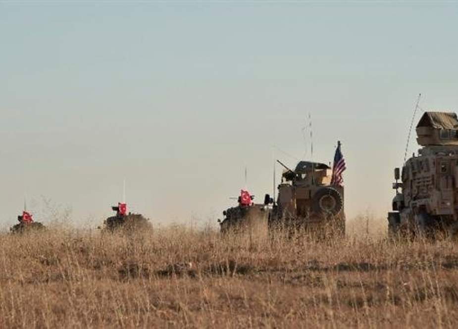 The file photo, taken on November 1, 2018, shows Turkish and US troops during a joint patrol around the Syrian town of Manbij. (AP)