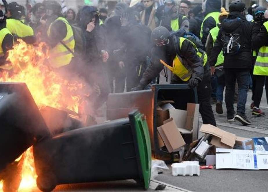 Protesters set trash cans ablaze during an anti-government demonstration called by the "yellow vests" (gilets jaunes) movement, on February 9, 2019 in Lorient, western France.