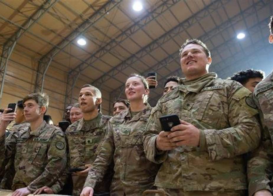 Members of the US military listen as President Donald Trump speaks during an unannounced trip to al-Asad Air Base, Anbar Province, Iraq, December 26, 2018. (Photo by AFP)