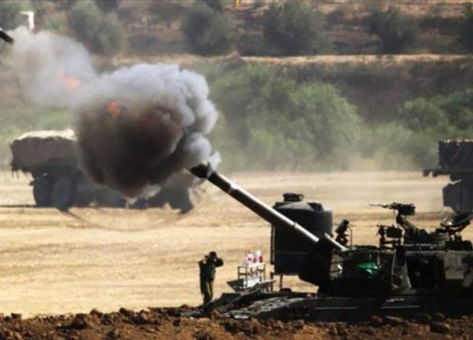 Israeli artillery gun fires a 155mm shell towards targets near the border