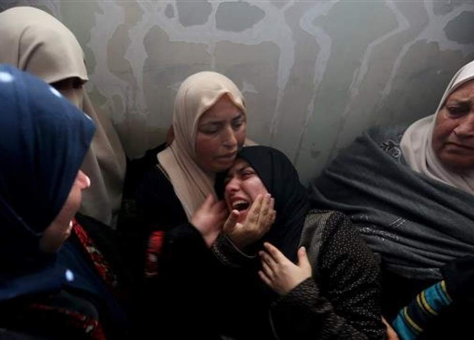 Relatives of Palestinian teen Hassan Iyad Shalabi , 14, who was killed during a protest at the border fence between the Gaza Strip and the Israeli-occupied territories, mourn during his funeral in the central Gaza Strip on February 9, 2019. (Photo by Reuters)