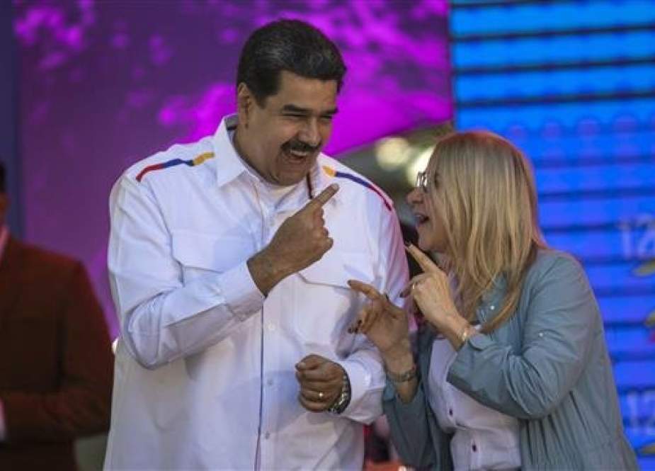 Venezuelan President Nicolas Maduro is seen with his wife, Cilia Flores, during a gathering of supporters in the capital, Caracas, on February 12, 2019. (Photo by AP)