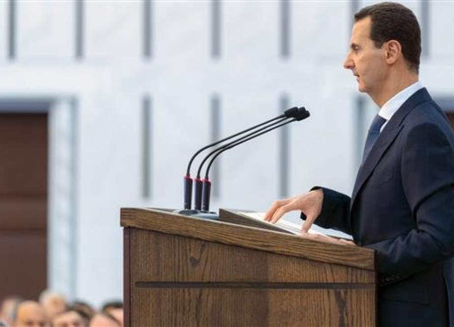 This handout picture released by the Syrian Presidency Facebook page on February 17, 2019, shows President Bashar al-Assad delivering a speech at a meeting for the heads of local councils in the capital Damascus, February 17, 2019, (via AFP)