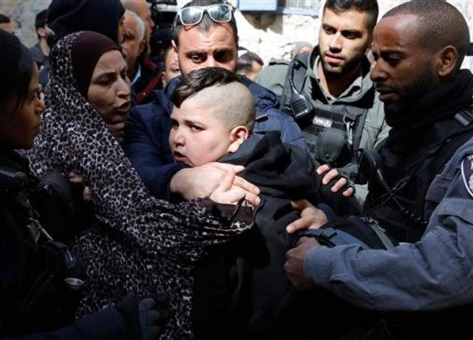 Israeli forces detain a member of the Abu Assab family as he protests their eviction from the house where they lived for many years, in the Old City of Jerusalem al-Quds, on February 17, 2019. (Photo by AFP)
