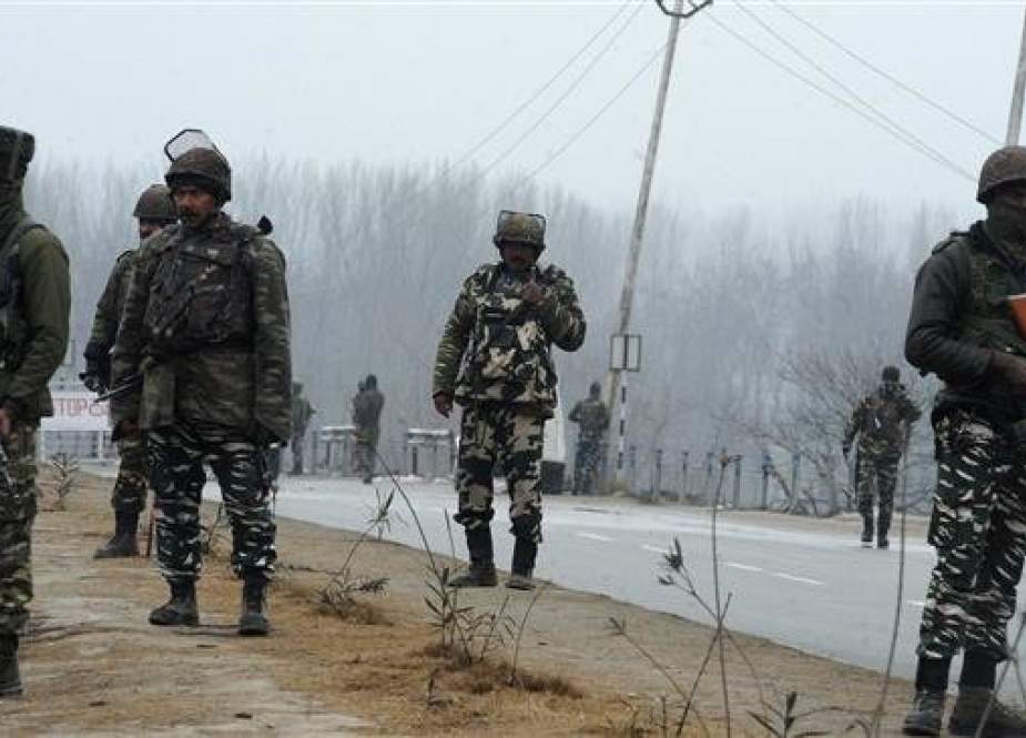 Indian forces stand guard along the Jammu-Srinagar highway. (Photo by AFP)