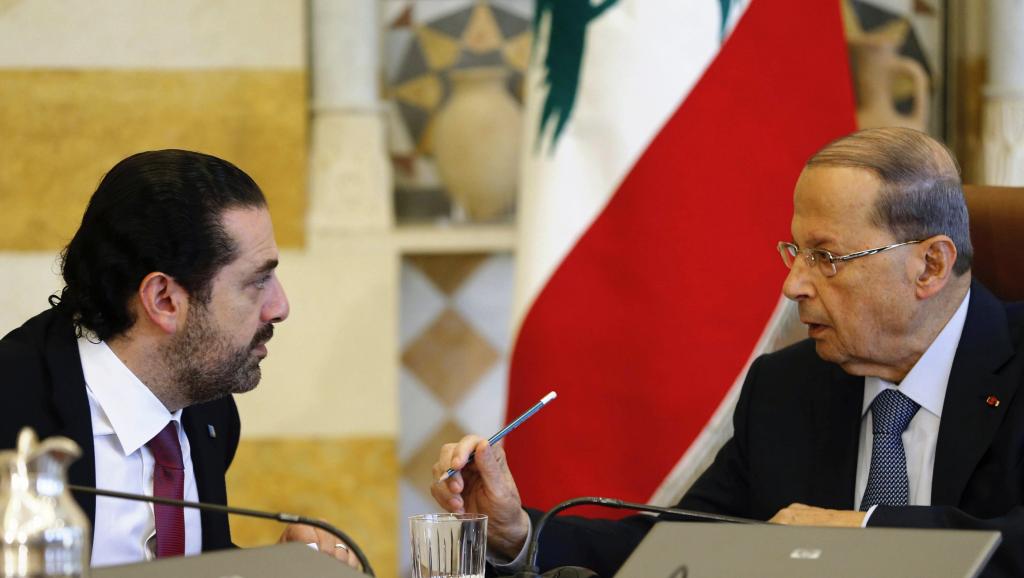 Lebanon’s President Michel Aoun talks to Prime Minister Saad Al Hariri during a cabinet meeting