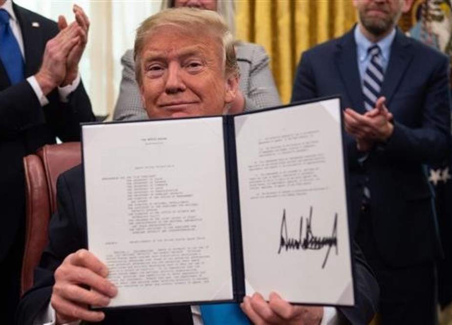 US President Donald Trump shows his signature on the Space Policy Directive-4 (SPD-4) on February 19, 2019, at the White House in Washington, DC. (Photo by AFP)