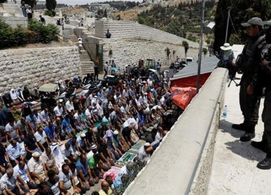 Palestinians pray outside the al-Aqsa Mosque compound in protest against the Israeli regime.jpg