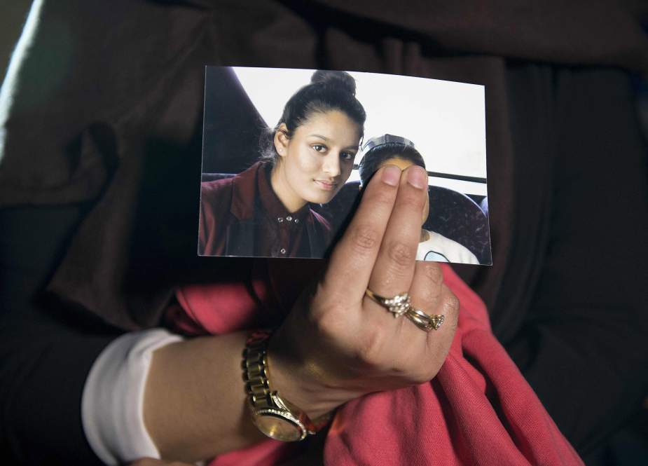 In this file photo taken on February 22, 2015, Renu Begum, eldest sister of missing British girl Shamima Begum, holds a picture of her sister while being interviewed by the media in central London.