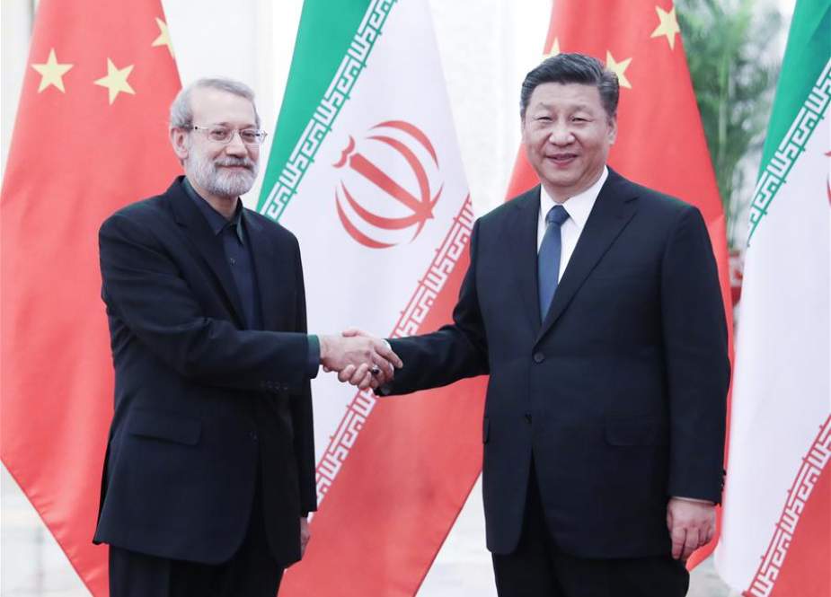 Chinese President Xi Jinping (R) and Iranian Parliament Speaker Ali Larijani shake hands before their meeting in Beijing, China, on February 20, 2019. (Photo by ICANA)