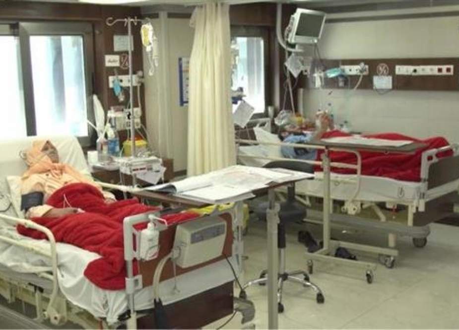 Patients lying in bed in a hospital in Iran