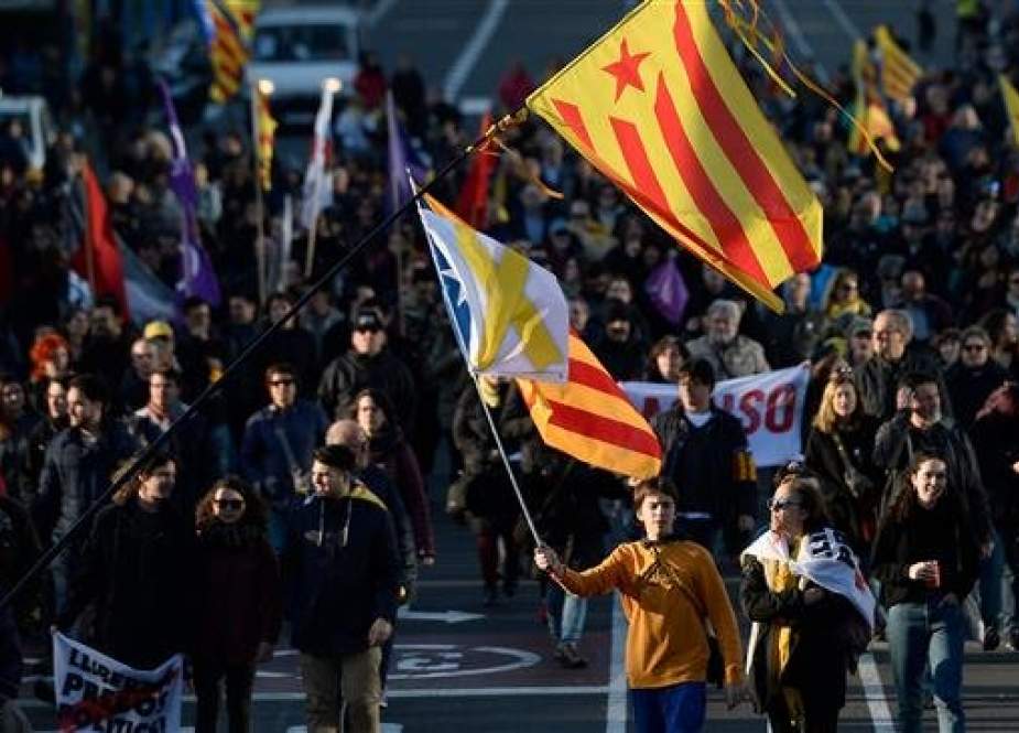 Demonstrators march towards the Catalonia