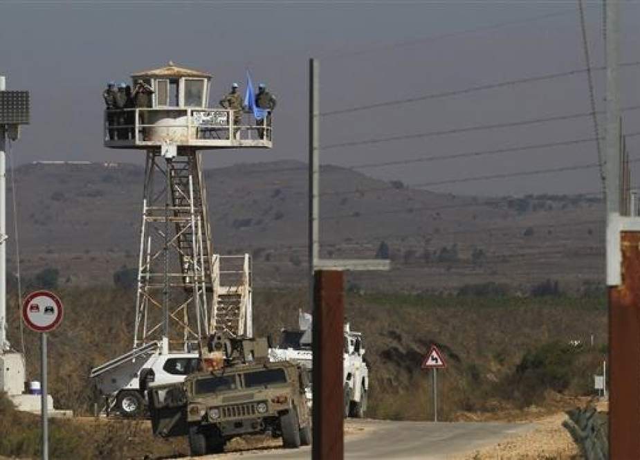UN troops stand near a watch tower at Syria
