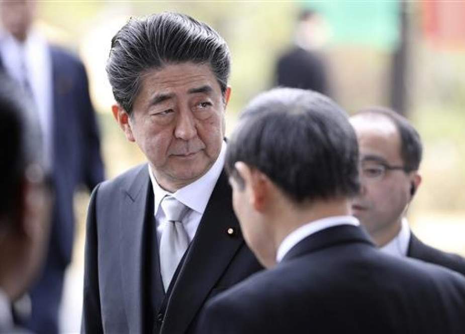Japanese Prime Minister Shinzo Abe (C) arrives at the National Theater for the ceremony to mark the 30th year of Emperor Akihito