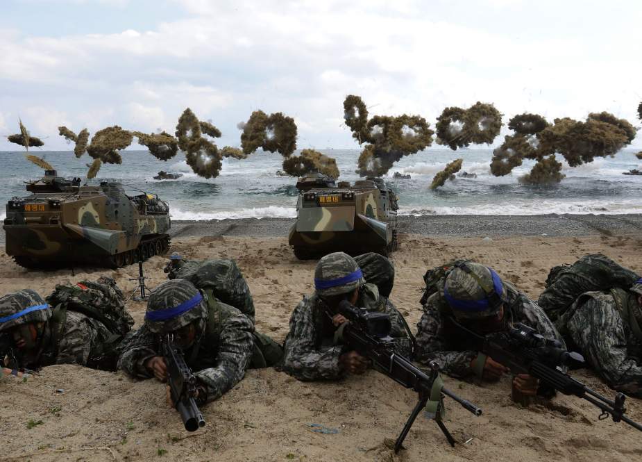 This file photo taken on April 2, 2017 shows South Korean Marines moving into position on a beach during a joint landing operation by US and South Korean Marines in the southeastern port of Pohang.
