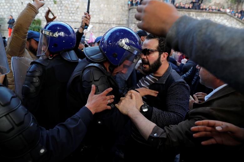 Police officers try to disperse people trying to reach the government palace during a protest against President Abdelaziz Bouteflika's plan to extend his 20-year rule by seeking a fifth term in April elections in Algiers, Algeria, March 1, 2019
