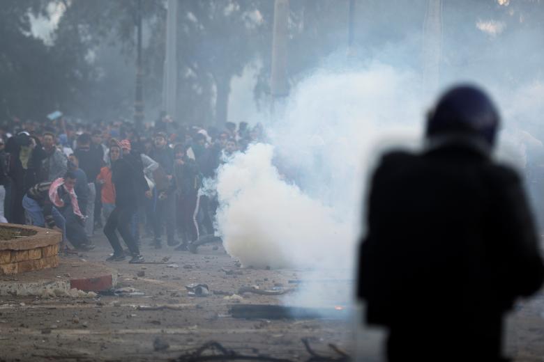 Anti-riot police officers clash with people protesting against President Abdelaziz Bouteflika's plan to extend his 20-year rule by seeking a fifth term in April elections in Algiers, Algeria, March 1