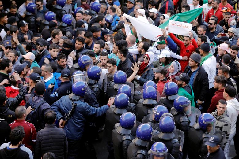 Police officers try to disperse people trying to reach the government palace during a protest against President Abdelaziz Bouteflika's plan to extend his 20-year rule by seeking a fifth term in April elections in Algiers, Algeria, March 1
