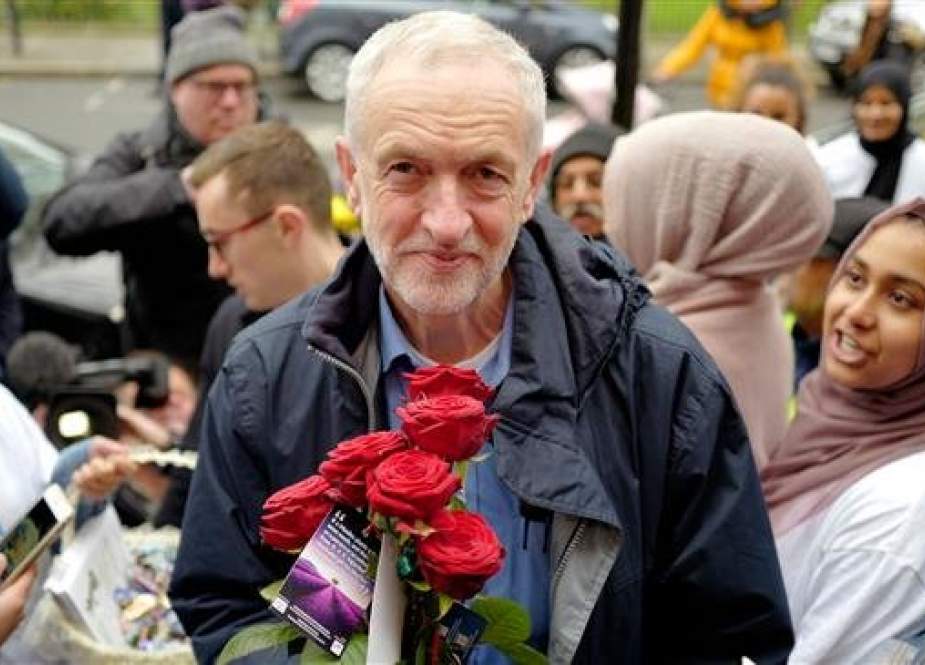Opposition Labour Party leader Jeremy Corbyn holds a rose as he arrives at Finsbury Park Mosque to mark national 