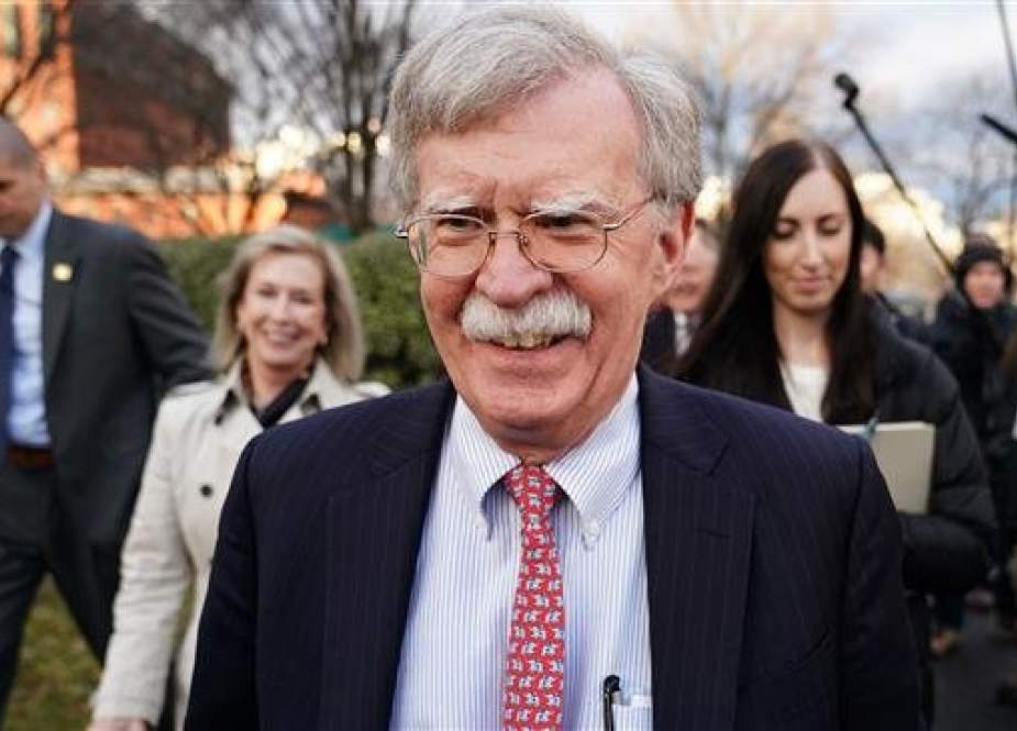 US National Security Adviser John Bolton walks on the driveway of the White House after an interview in Washington, DC, on January 24, 2019. (Photo by AFP)