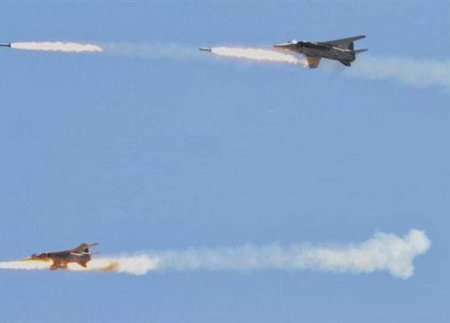 The file photo shows two Syrian Air Force fighter jets firing missiles.