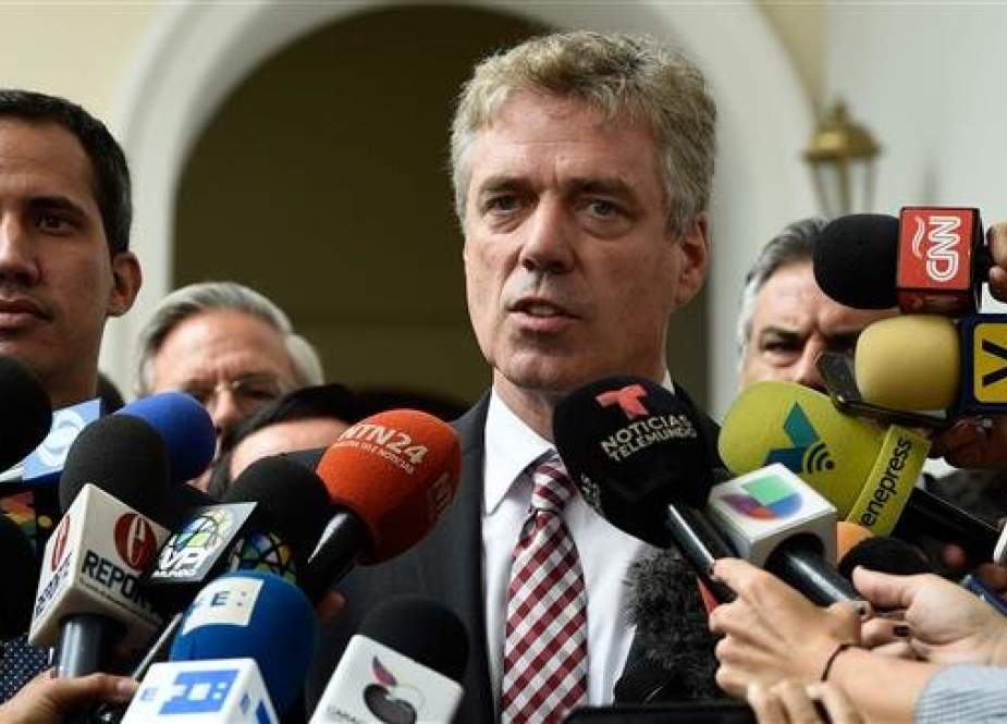 In this file photo, taken on February 19, 2019, German Ambassador to Venezuela Daniel Kriener speaks to journalists after attending a meeting with Venezuelan opposition leader Juan Guaido, left, at the defunct National Assembly in Caracas. (By AFP)