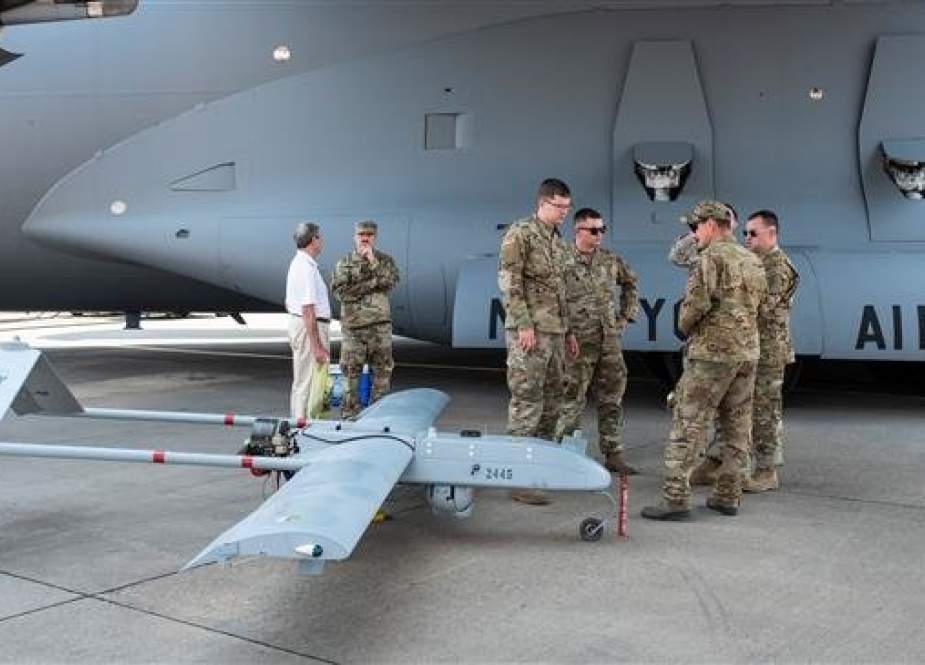 US soldiers stand next to a RQ7 Bravo Shadow Drone, under the wing of a C17 Globemaster III, during the Africa Aerospace and Defense Expo on September 20, 2018, in South Africa. (AFP photo)