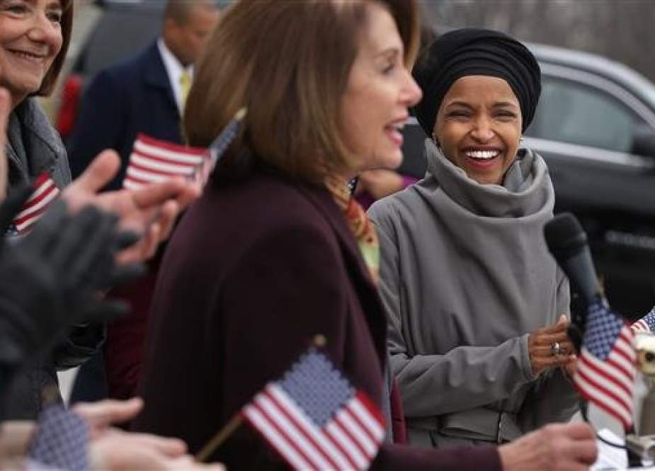 US Rep. Ilhan Omar (D-MN) (R) listens to Speaker of the House Nancy Pelosi (D-CA) during a rally for H.R. 1, or the We The People Act, on the East Steps of the US Capitol on March 08, 2019 in Washington, DC. (AFP photo)